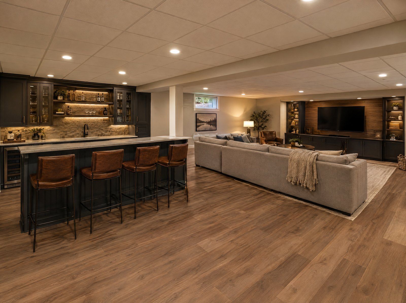 Finished basement with wet bar, drop ceiling lighting and lounge area